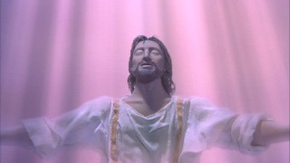 Just baptized by John, Jesus Christ basks in the pink light of the Holy Spirit.