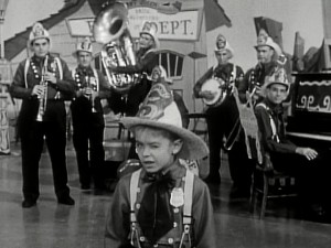 Mouseketeer Cubby winks as animator Ward Kimball's Dixieland band the Firehouse 5 + 2 show up for "Anything Can Happen Day."