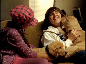 Mitchel Musso enjoys the company of dogs in his "Lean on Me" music video from the "Snow Buddies" DVD.