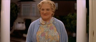 Mrs. Doubtfire flashes a slight, warm smile while making her grand entrance at the Hillards' front door.
