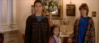 Playing the Hillard children with their layered '90s looks are Lisa Jakub ("Independence Day"), Mara Wilson ("Matilda"), and Matthew Lawrence ("Boy Meets World").