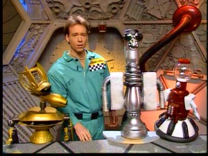 At the prompting of his robot buddies, series creator and original host Joel Hodgson tries asking a question of a state-of-the-art new bot.