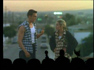 The martial alien (Daniel Bernhardt) and the tough hooker-turned-nun (Travis Brooks Stewart) display '90s fashion (plaid, layers) while having a magic hour chat in the oddly appealing "Future War."