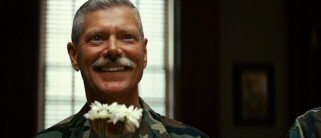 Fresh flowers bring a big smile to the face of Brigadier General Dean Hopgood (Stephen Lang of "Avatar" fame).