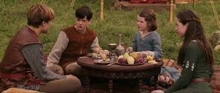 The four Pevensie siblings share a meal.