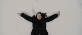 Susan (Anna Popplewell) makes a snow angel in the Pevensie children's extended introduction to Narnia.