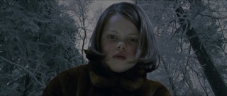 Lucy (Georgie Henley) looks at a frozen fish in this not-quite-finished looking addition.