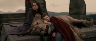 Susan and Lucy are at Aslan's side on the Stone Table.