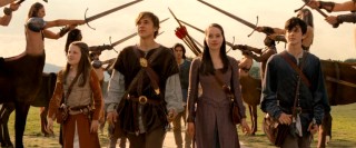 The Pevensie children (Georgie Henley as Lucy, William Moseley as Peter, Anna Popplewell as Susan, and Skandar Keynes as Edmund) are proud to get a royal welcome in Narnia, where they're recognized as kings and queens.