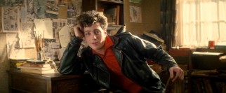 A teenaged John Lennon (Aaron Johnson) shoots a loving look at his very first guitar in "Nowhere Boy."