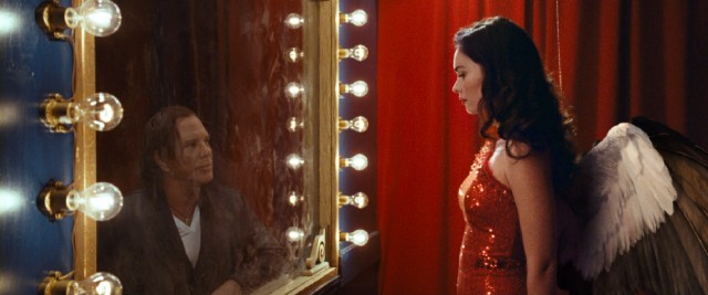 Trumpet man Nate Poole (Mickey Rourke) is captivated by the stunning sight of winged sideshow angel Lily Luster (Megan Fox) in "Passion Play."