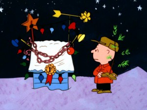 Though glitz won his dog a ribbon in the lights and display contest, Charlie Brown prefers the simple joys of this pathetic little Christmas tree.