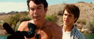With cocaine on his upper lip, Derrick Jones (Jerry O'Connell) grabs the camera from Jake (Steven R. McQueen) to ensure the filming of a nude parasailer.