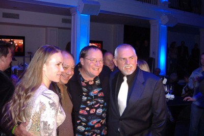 An unidentified woman, voice actors, and Pixar's big cheese: Cheech Marin, John Lasseter, and John Ratzenberger strike a pose.