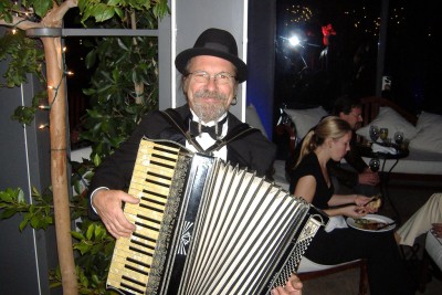 An accordion player politely poses.