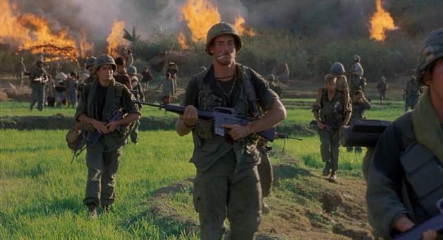 Having carried out their orders to torch the farm village, the soldiers of Bravo Company (including John C. McGinley) move on to their next objective in "Platoon."