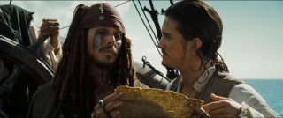 Captain Jack and Will Turner lay out their cards aboard the Black Pearl.