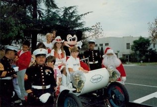 Priscilla, with Mickey Mouse, spreads holiday cheer at the 1984 Bakersfield Christmas Parade.