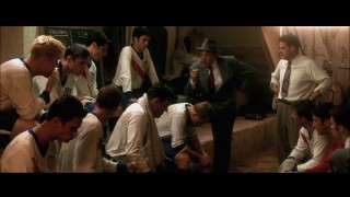 Coach John Rhys-Davies wants to know which of his players shaved his beard. Notice Zachery (Ty) Bryan trying to look especially casual on the far left.