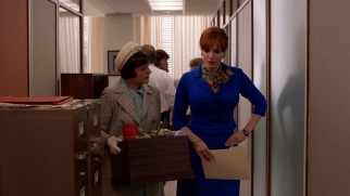 Joan (Christina Hendricks) experiences pelvic pains as she shows Peggy (Elisabeth Moss) and others to their workspaces at the newly-merged agency.