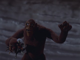 It, a giant ape resembling King Kong, holds the comparably diminutive Mad Monster Party cast in his hand in the film's climax.