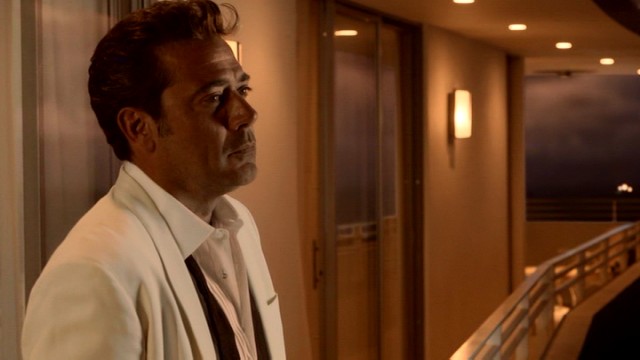 Ike Evans (Jeffrey Dean Morgan) takes in the ocean view from the balcony of his glamorous hotel.