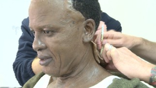 Idris Elba is creepily fitted with a Mandela face prosthetic in "Prosthetics & Costuming."