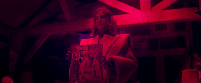 Androgynous cult leader Jeremiah (Linus Roache) shows off the album he made to the captive Mandy.