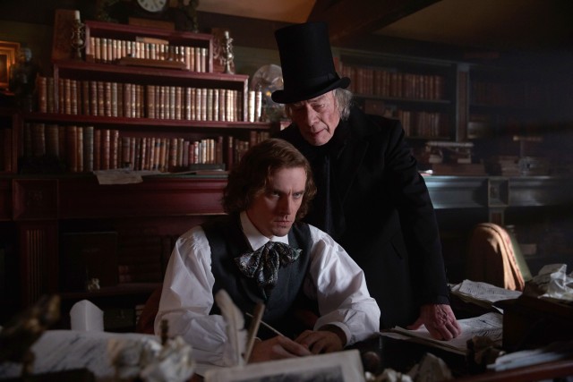 Ebenezer Scrooge (Christopher Plummer) materializes and stands over Charles Dickens (Dan Stevens) in "The Man Who Invented Christmas."