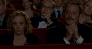 Joan (J. Smith-Cameron) and Ramon (Jean Reno) go to the opera on a date.
