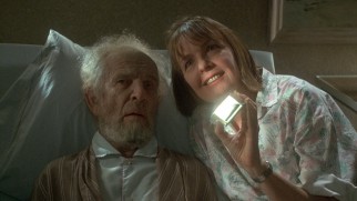 Like a cat, Marvin (Hume Cronyn) is entertained by light reflections on a wall.