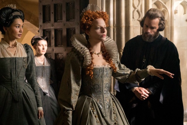 A transformed Margot Robbie portrays Elizabeth I, the Queen of England, whose confidantes include the quiet Bess of Hardwick (Gemma Chan) and the less quiet Sir William Cecil (Guy Pearce).