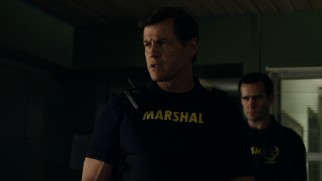 Christopher Blake (Michael Par) is calling the shots this Friday night and his vest should read "Mercenary" instead of "Marshal."