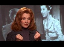 Stefanie Powers remembers "McLintock!" in front of a frame of herself in the movie.