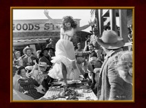 Maureen O'Hara tramples a table of food in this photo gallery film still.