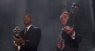 Agents J (Will Smith) and K (Tommy Lee Jones) wield large weapons for their climactic battle at Flushing Meadows-Corona Park, the site of the New York World's Fair.