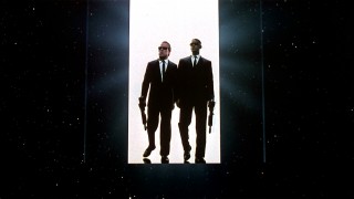 Agents K and J bust open a door that becomes the I in the "Men in Black" trailer's MIB logo.