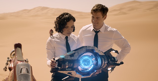 Agents M (Tessa Thompson) and H (Chris Hemsworth) end up in the desert with the tiny, chatty Pawny (voiced by Kumail Nanjiani) in "Men in Black: International."