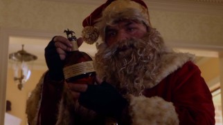 Hobo Santa (Oliver Platt) truly does prefer bourbon to cookies and milk.