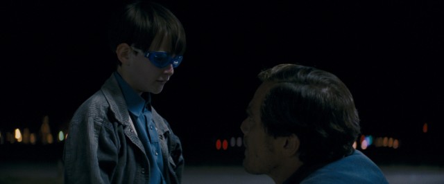 Alton (Jaeden Lieberher) has a chat with his biological father (Michael Shannon) in a convenience store parking lot where satellites are about to descend in "Midnight Special."