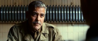 The mustachioed Frank Stokes (George Clooney) does some monologuing for a cocky Nazi war criminal.