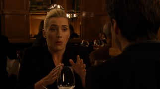 Beth (Kate Winslet) can no longer ignore the balls dangling from her blind date's neck.
