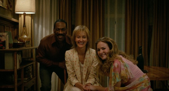 The happy family of three: Mr. Church (Eddie Murphy), Marie (Natascha McElhone), and Charlie (Britt Robertson) pose for a timed photo before Charlie's prom.