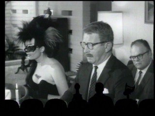 In the longest shot of the film, Batwoman (Katherine Victor) conducts a séance that inexplicably keeps breaking down into an offensively fake approximation of the Chinese language.