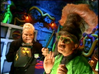 TV's Frank (Frank Conniff) gives Dr. Clayton Forrester (Trace Beaulieu) an atomic hair makeover.