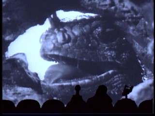 Scientists are corned in a cave and fear death by gumming by this "giant" iguana in "King Dinosaur."