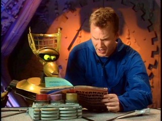 Crow and Mike (Michael J. Nelson) read up on alternate universes after an ion storm incident jostles their world's order.