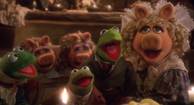 The Cratchit family -- Robin as Tiny Tim, Kermit as Bob, Miss Piggy as Emily -- give thanks for their few blessings this Christmas.