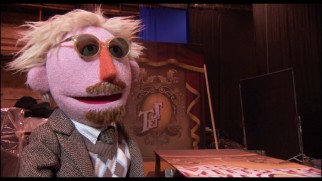 The Muppet version of director James Bobin objects to the curtain's botched title logo in this Easter egg.