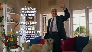 In a shot exclusive to the theatrical trailer, Leslie Nielsen smiles and waves while a dog gets personal and credits are displayed.